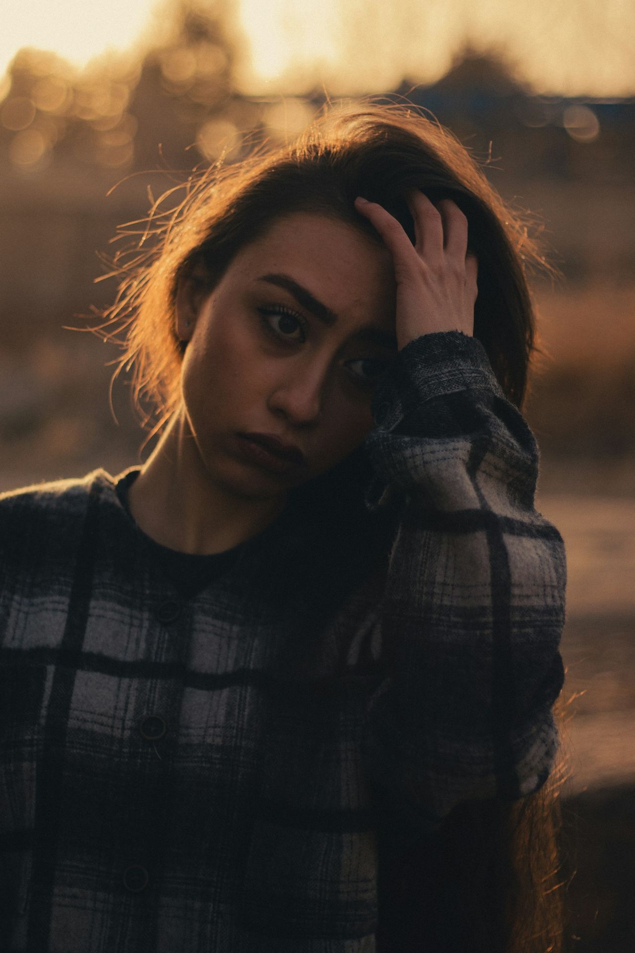 a woman with her hand on her head
